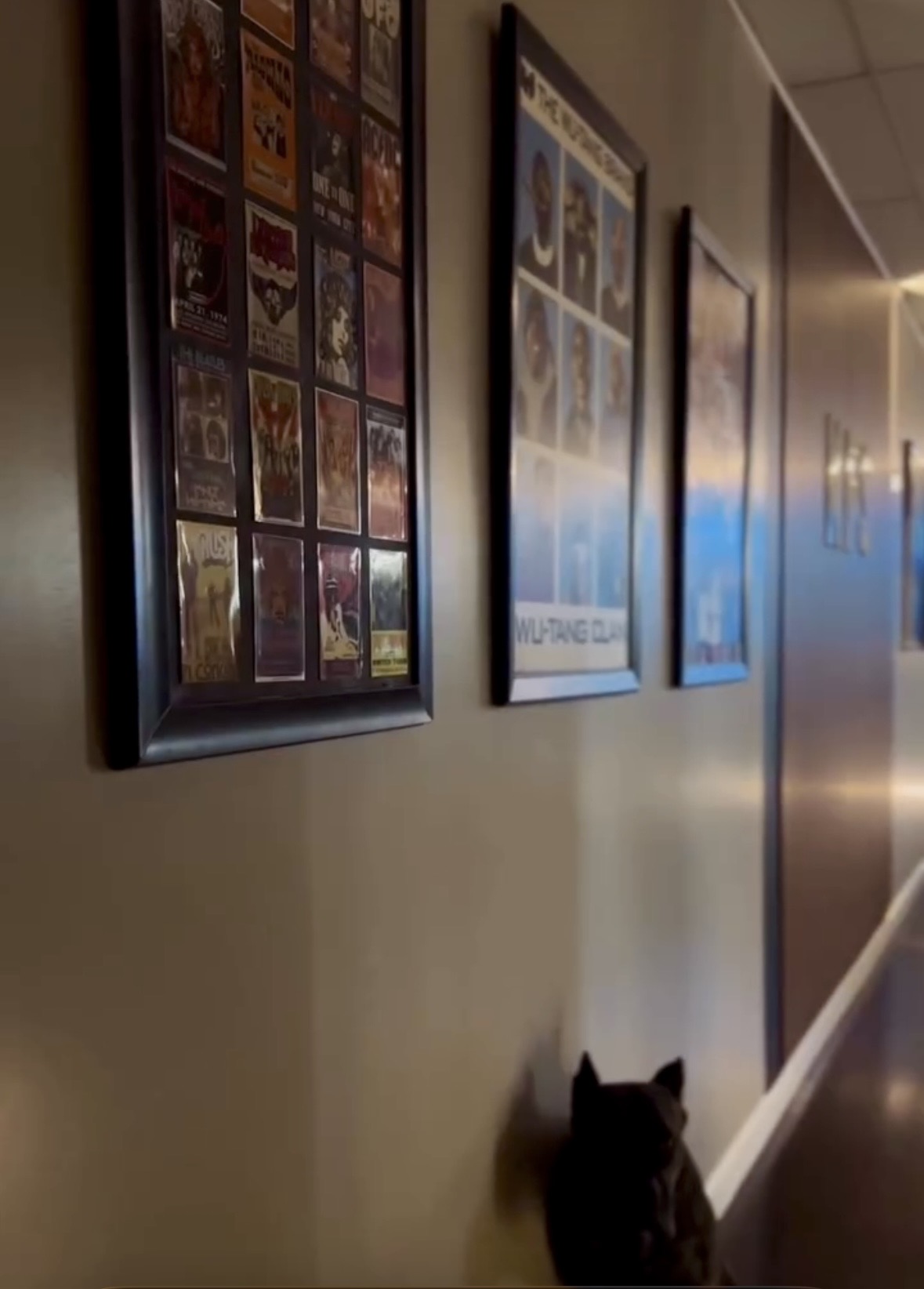 Framed music memorabilia along the studio hallway