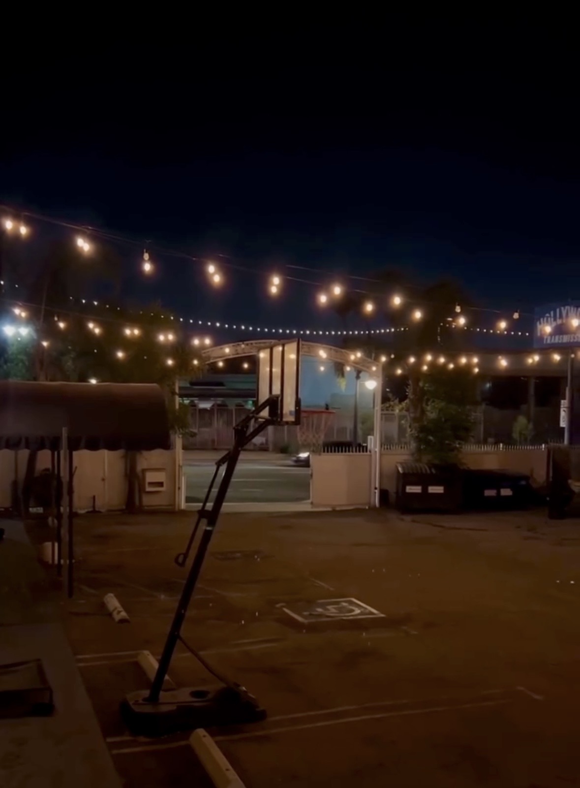 Outdoor studio courtyard under string lights at night